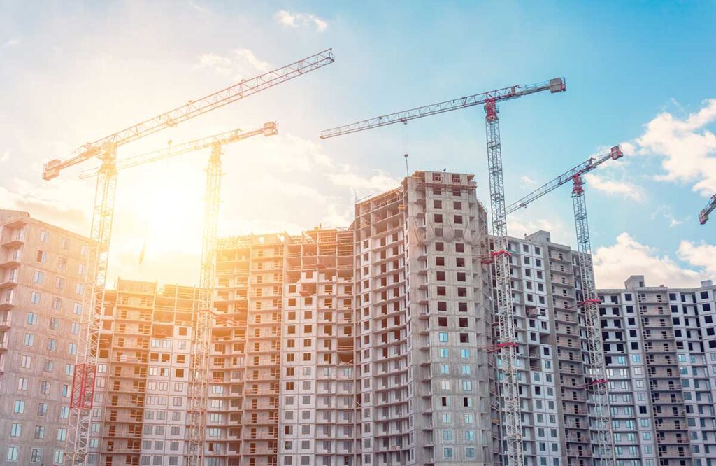 View large-scale construction of a residential complex with a view of construction cranes.