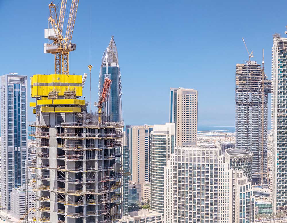 Dubai downtown at sunny day timelapse, luxury modern buildings and construction site, futuristic cityscape of United Arab Emirates. Aerial top view from skyscraper